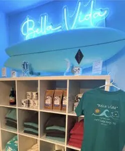 Cozy surf shop interior with surfboard decor and beach-themed merchandise.